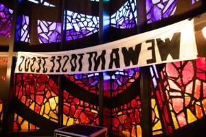 A banner that says, "WE WANT TO SEE JESUS," is hung in Logsdon Chapel.
